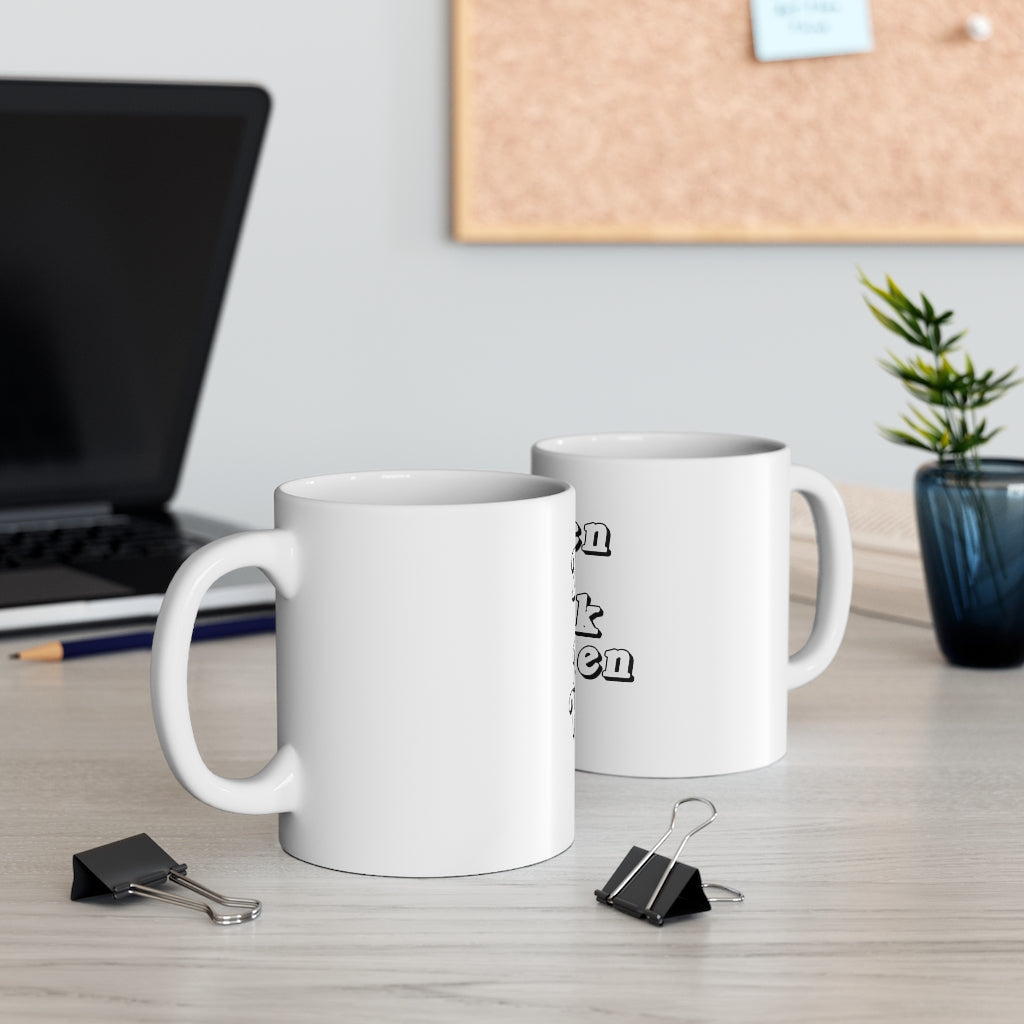 a coffee mug sitting on a table next to a coffee mug 